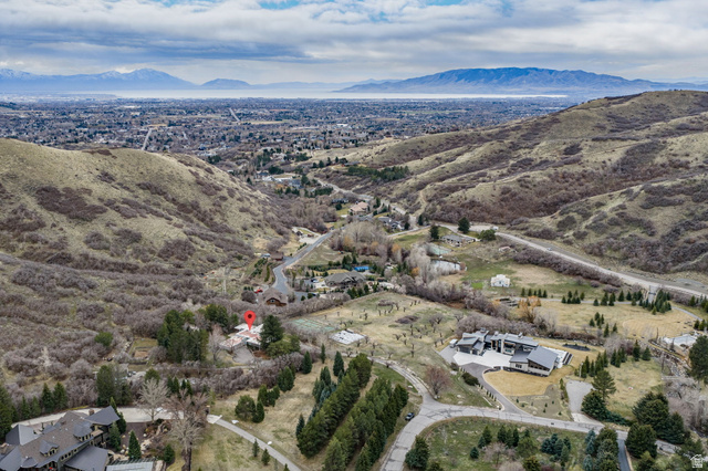 1856 Fort Canyon Road Alpine, UT 84004 - Photo 11 of 49 Elevated property set against a backdrop of rolling hills and distant mountains, featuring a diverse landscape with mature trees and open terrain