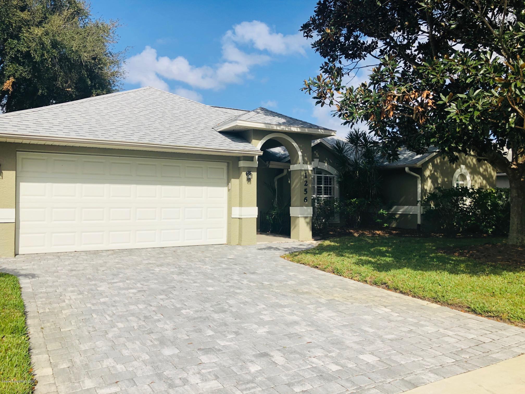 1256 Winding Meadows Road Rockledge, FL 32955 - Photo 1 of 16 a front view of a house with a yard and garage
