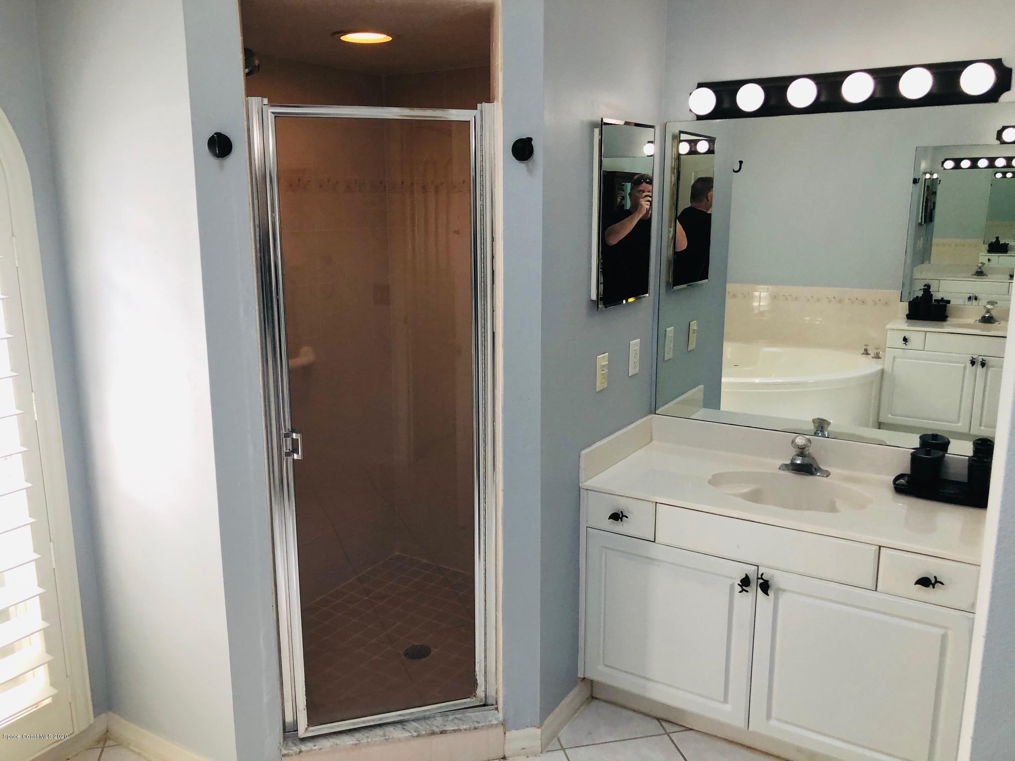 1256 Winding Meadows Road Rockledge, FL 32955 - Photo 11 of 16 a bathroom with a sink and a mirror