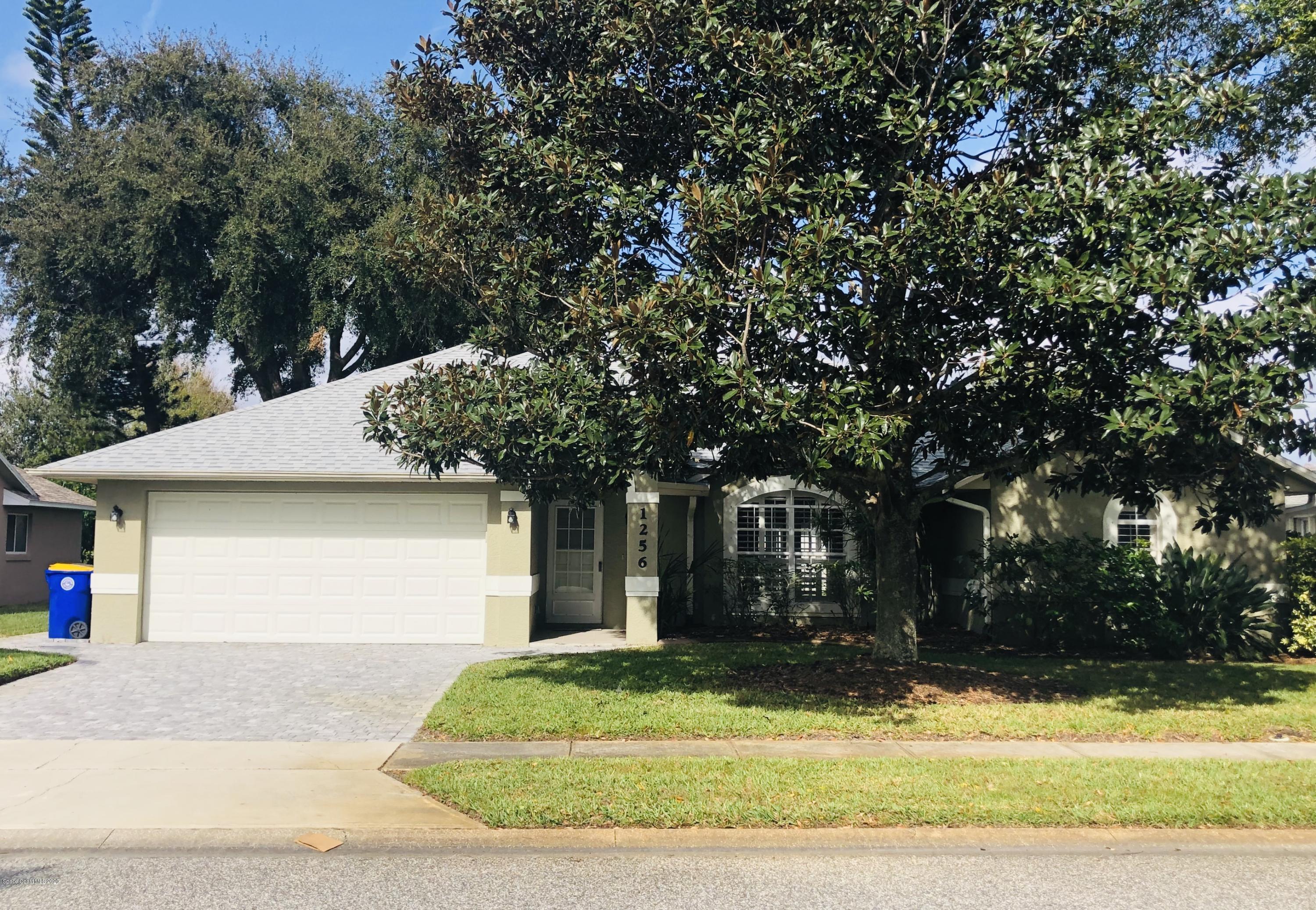 1256 Winding Meadows Road Rockledge, FL 32955 - Photo 16 of 16 a front view of a house with a yard and garage