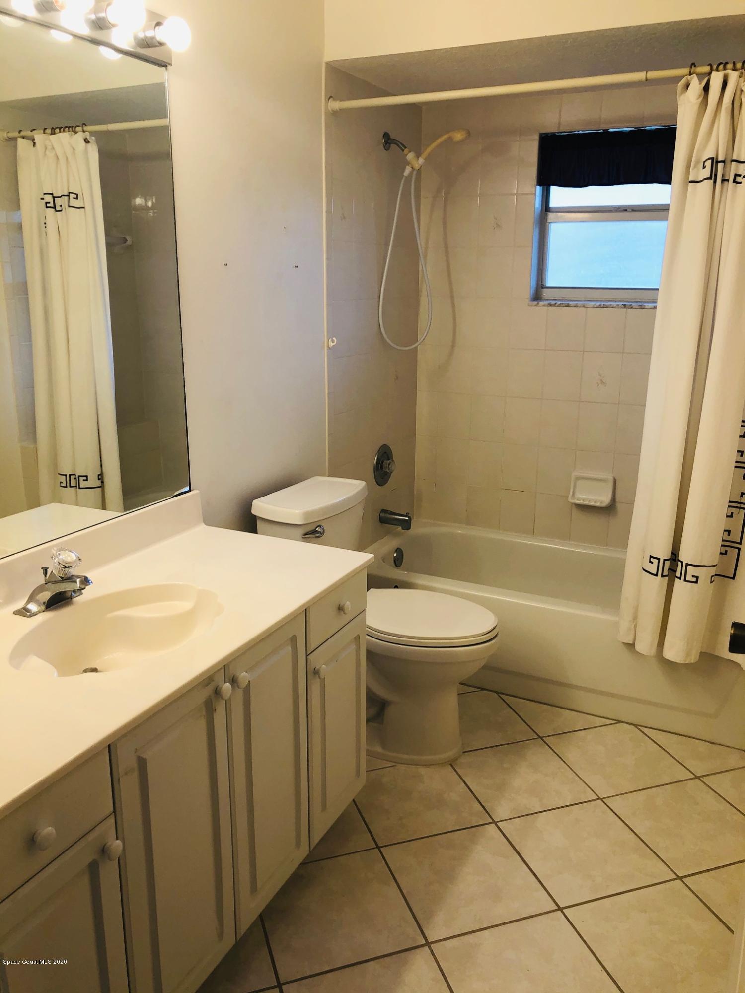 1256 Winding Meadows Road Rockledge, FL 32955 - Photo 5 of 16 a bathroom with a granite countertop sink toilet and shower