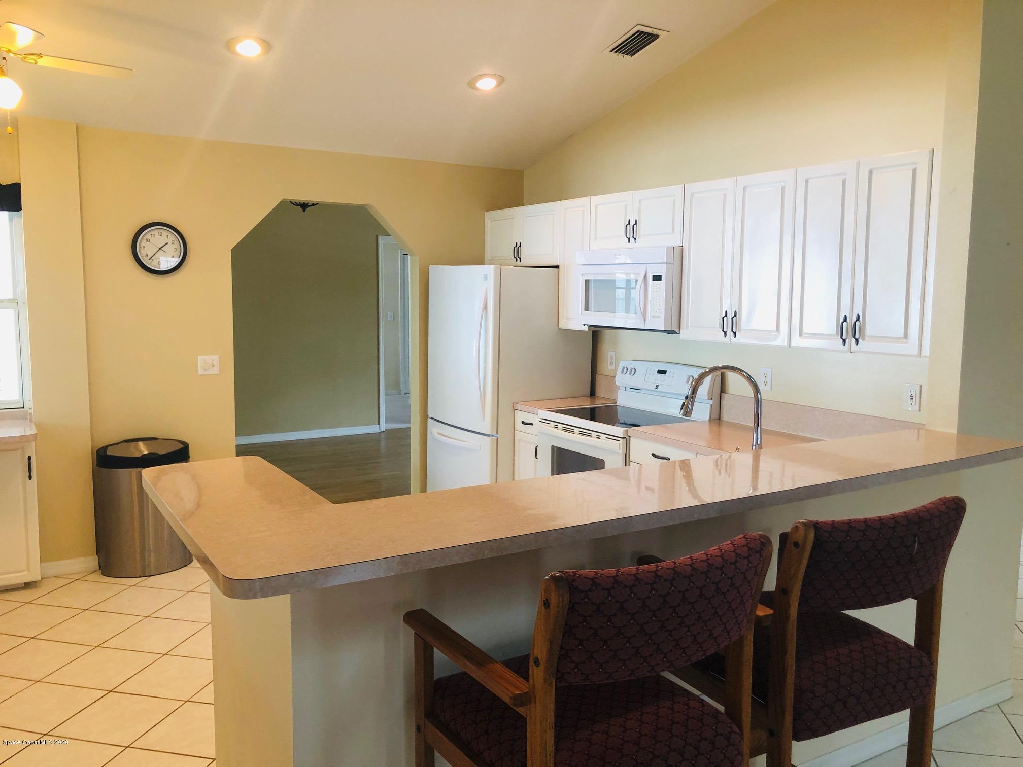 1256 Winding Meadows Road Rockledge, FL 32955 - Photo 6 of 16 a kitchen with stainless steel appliances a sink and a refrigerator