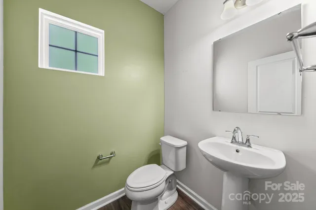 a bathroom with a sink toilet and a mirror