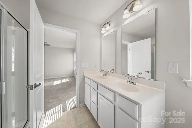 a bathroom with 2 sink and a mirror