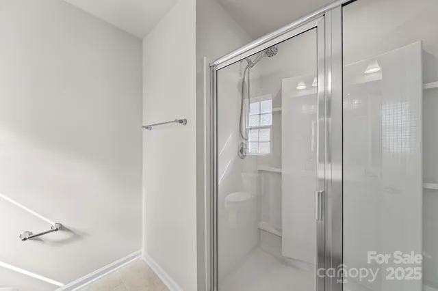 a bathroom with a glass shower door