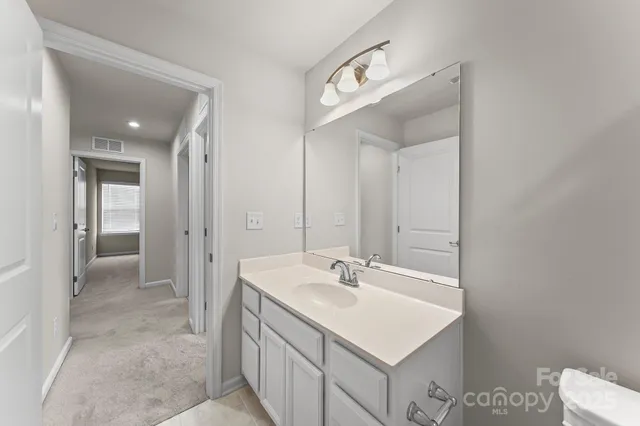 a bathroom with a sink mirror and a shower