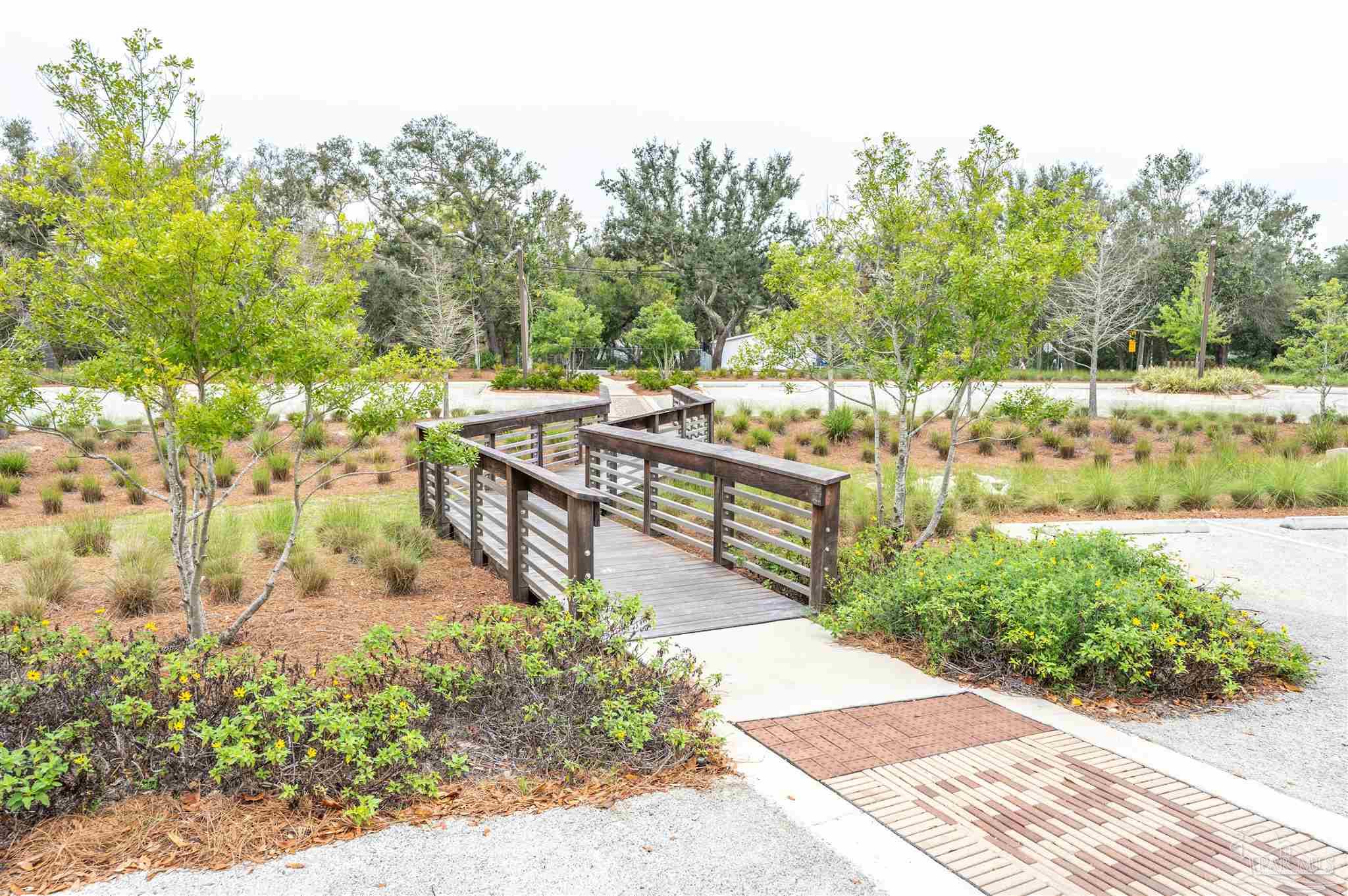 5661 Galvez Road Pensacola, FL 32507 - Photo 14 of 60 a view of a pathway with a bench in front of it