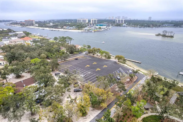 an aerial view of residential houses with outdoor space and trees