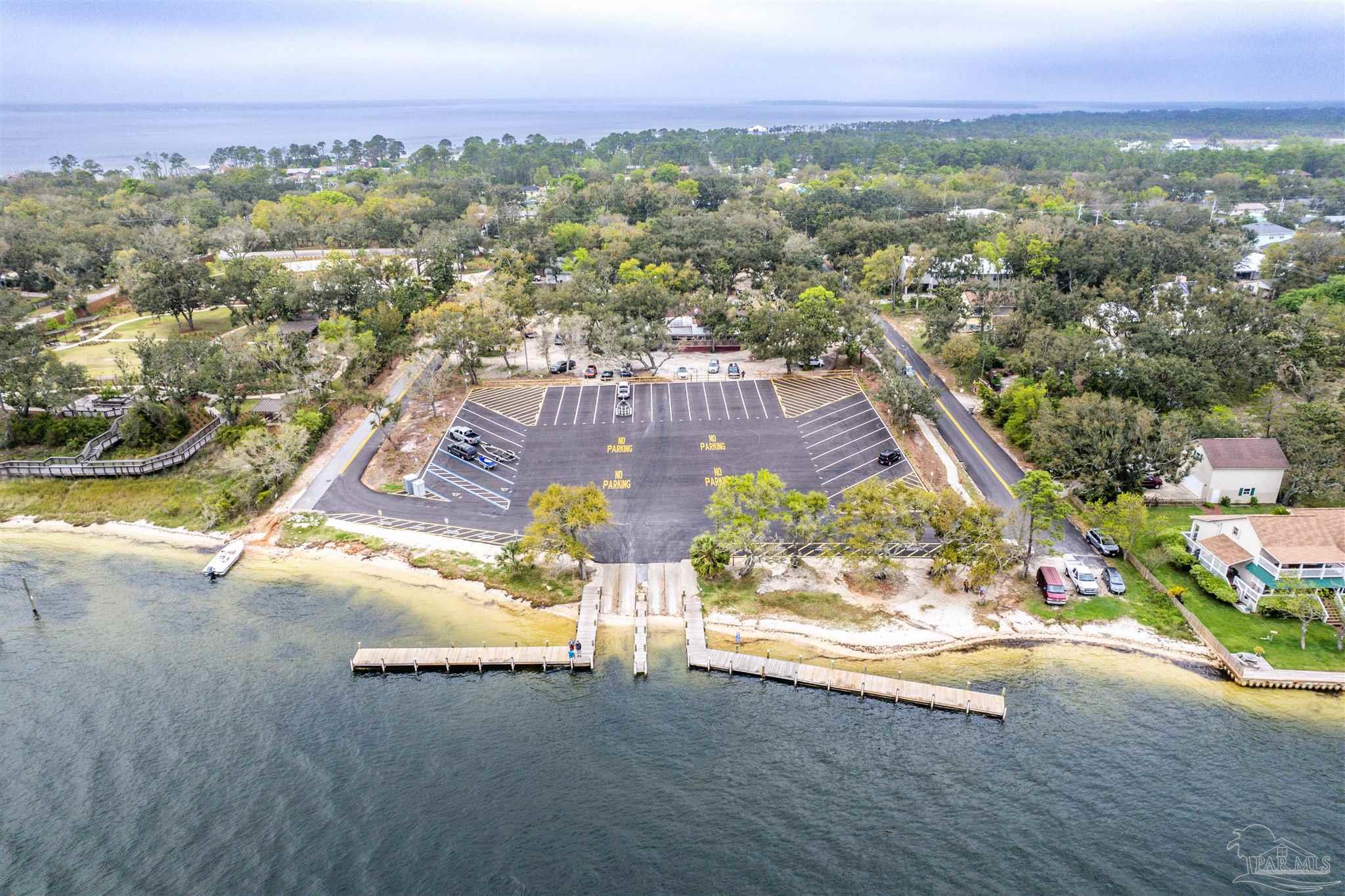 5661 Galvez Road Pensacola, FL 32507 - Photo 21 of 60 an aerial view of residential houses with outdoor space and trees