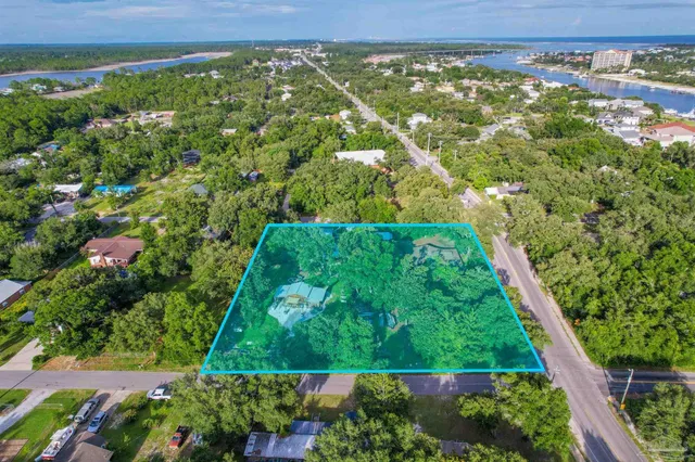 a front view of a house with swimming pool and table and chairs