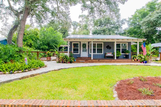 a view of a house with a yard patio and swimming pool
