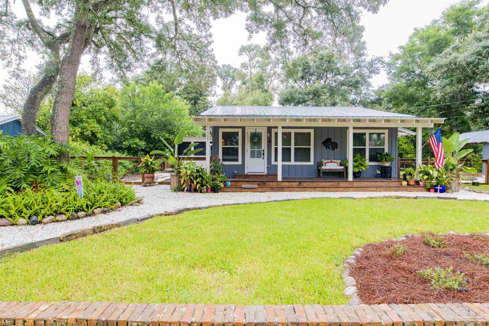 5661 Galvez Road Pensacola, FL 32507 - Photo 32 of 60 a view of a house with swimming pool and porch