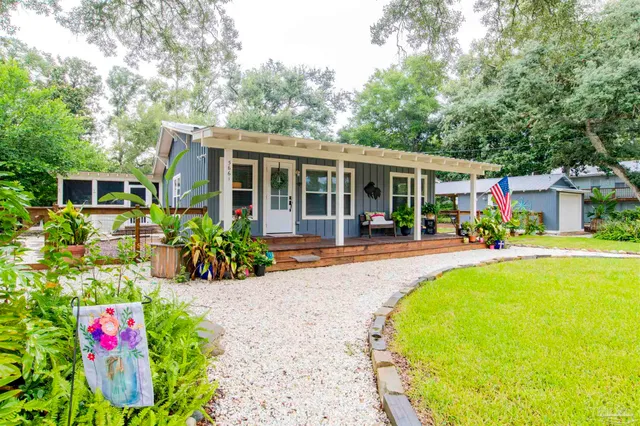 a view of a house with a yard and sitting area
