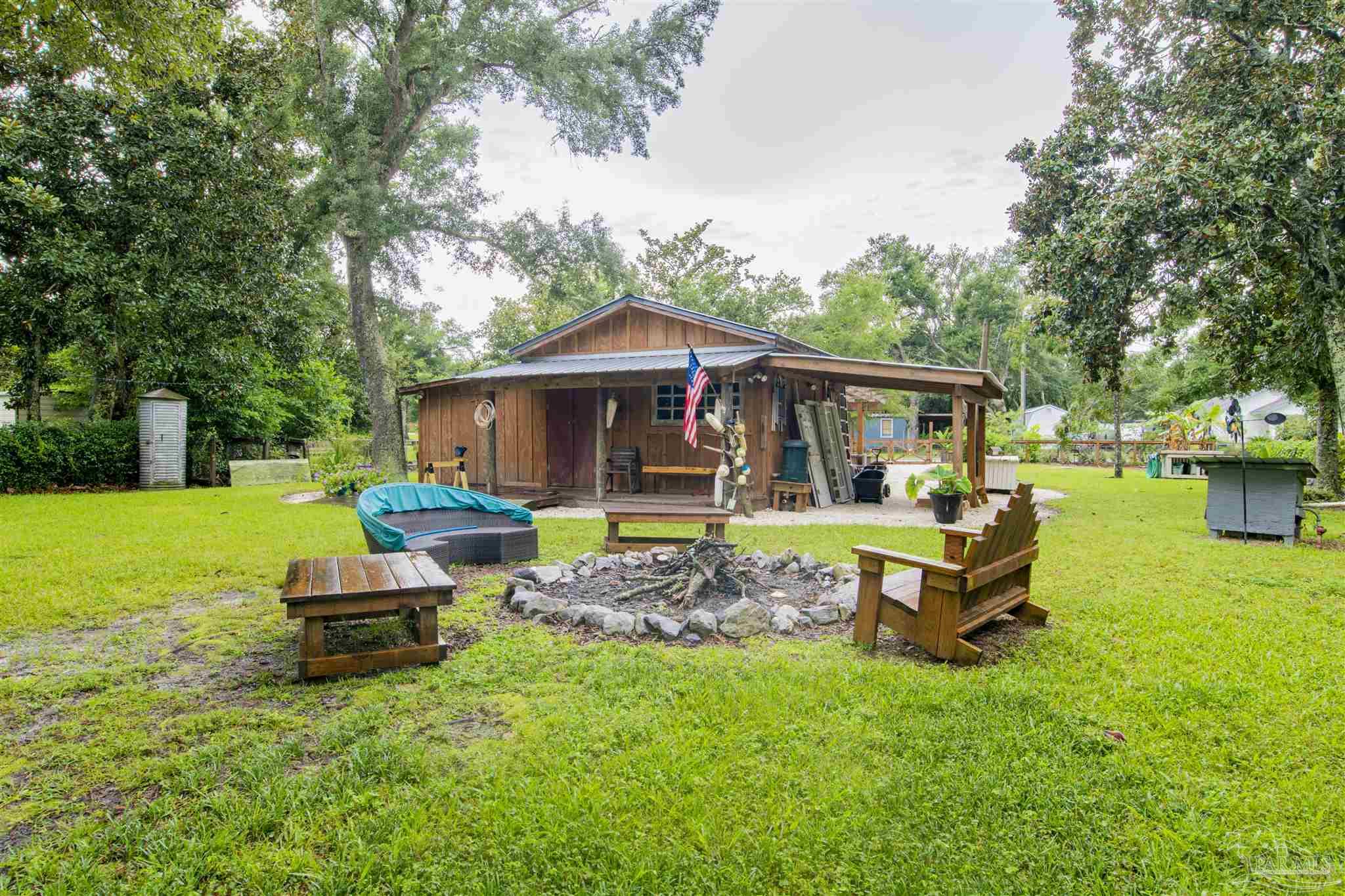 5661 Galvez Road Pensacola, FL 32507 - Photo 37 of 60 a front view of a house with garden
