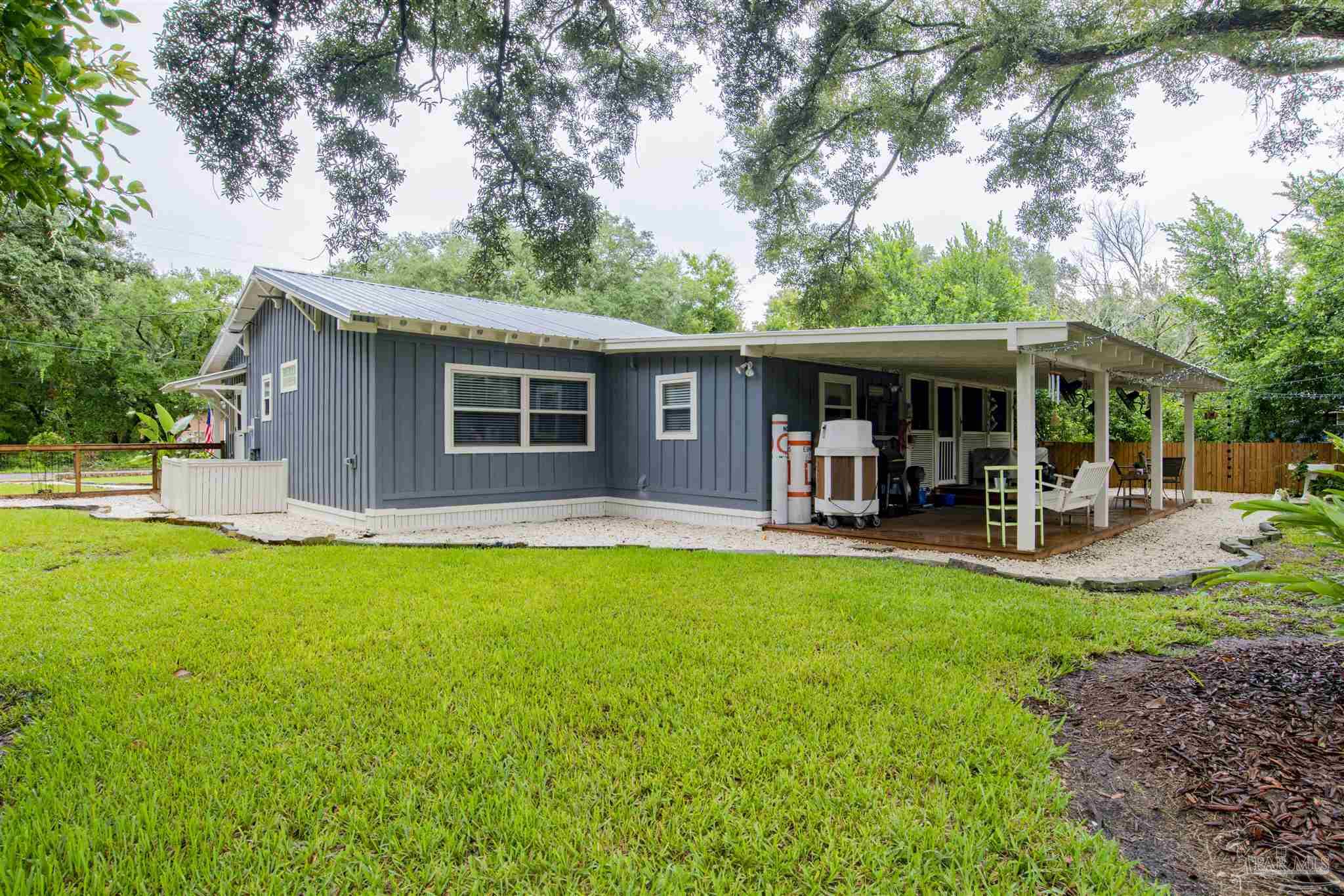 5661 Galvez Road Pensacola, FL 32507 - Photo 40 of 60 a view of a house with a yard patio and swimming pool