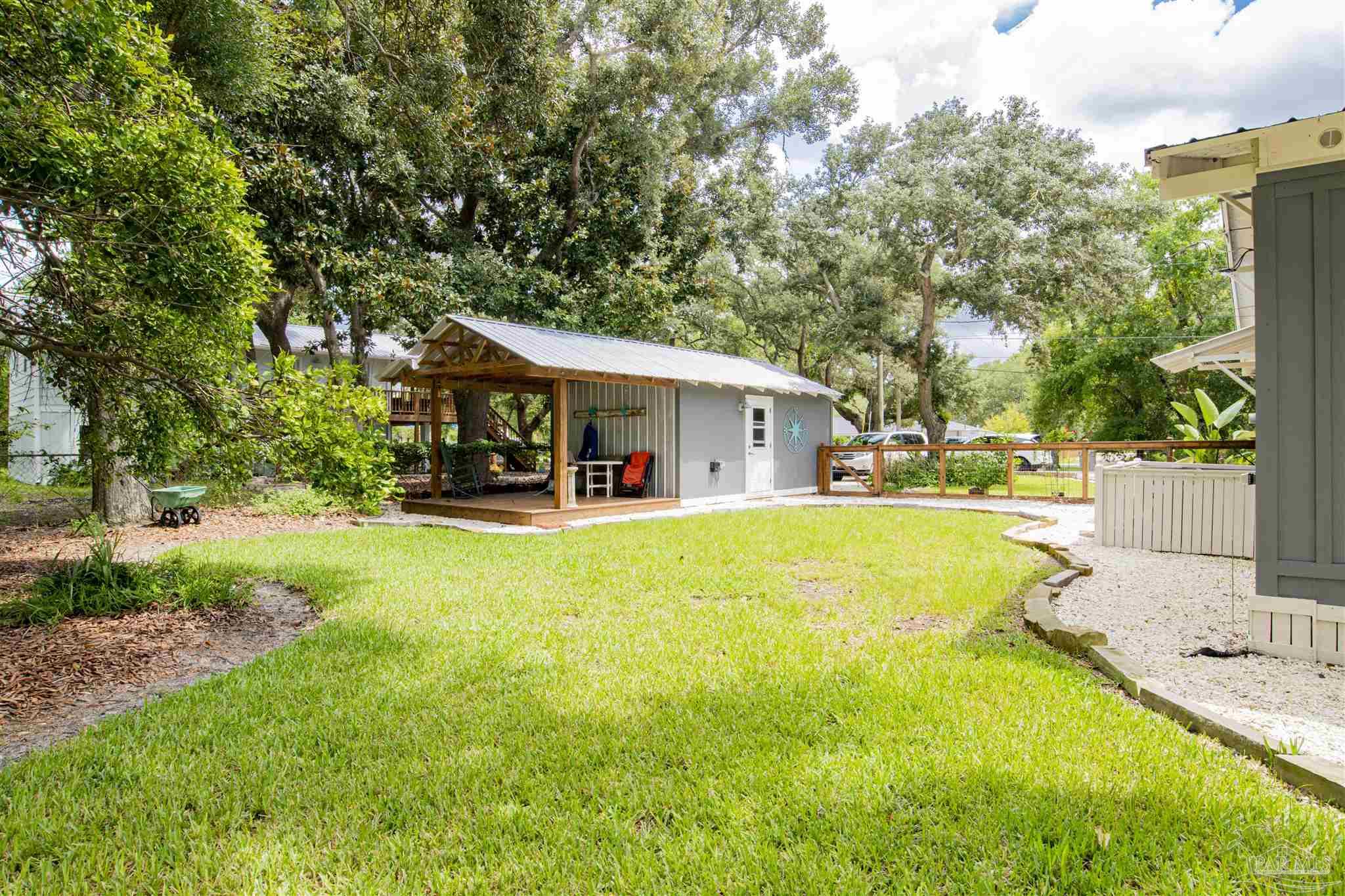 5661 Galvez Road Pensacola, FL 32507 - Photo 56 of 60 a view of house and swimming pool with lawn chairs and plants