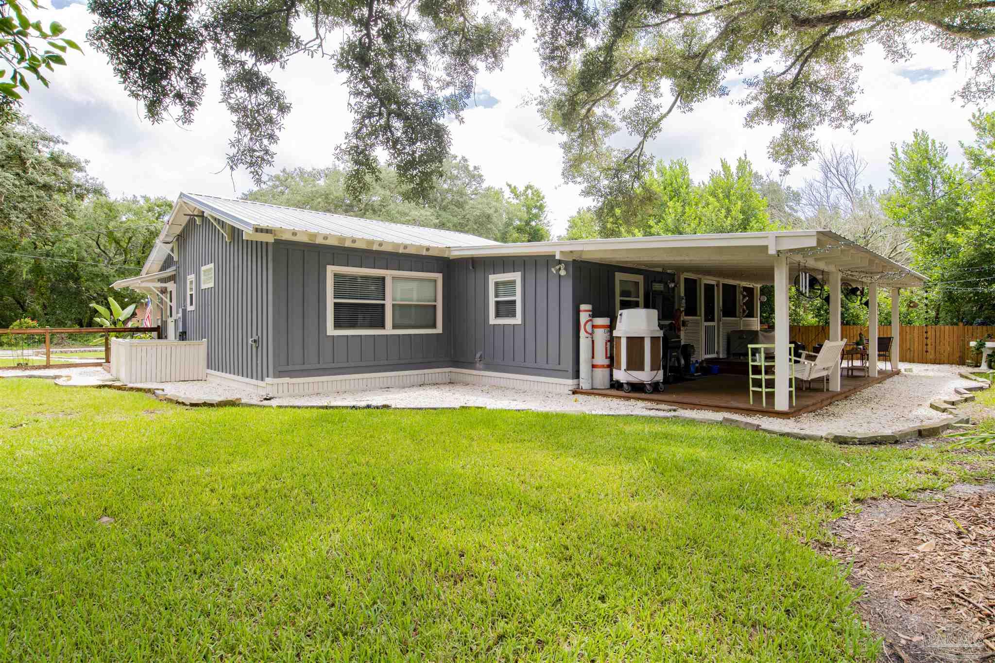 5661 Galvez Road Pensacola, FL 32507 - Photo 57 of 60 a view of a house with swimming pool and porch
