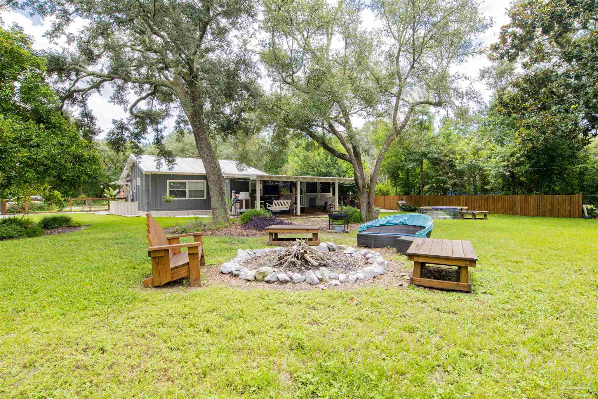 5661 Galvez Road Pensacola, FL 32507 - Photo 59 of 60 a backyard of a house with table and chairs