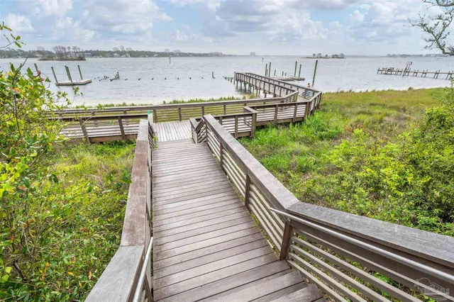a view of a park with slide and potted plants