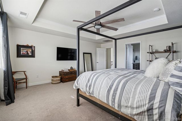 a bedroom with bed tv and couch