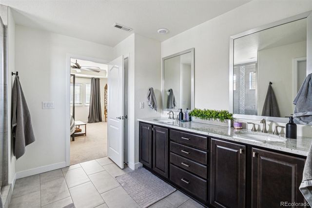 a spacious bathroom with a double vanity sink and a mirror