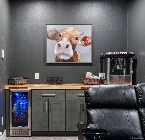 a living room with furniture and wall paintings