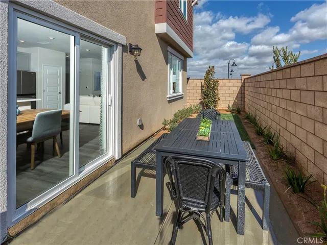 a balcony with table and chairs