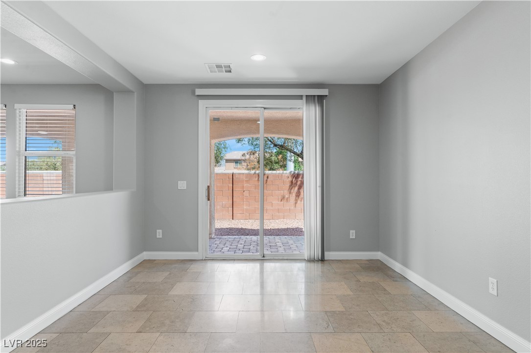 312 Pocono Ranch Avenue North Las Vegas, NV 89031 - Photo 9 of 34 Empty room with visible vents, baseboards, and plenty of natural light