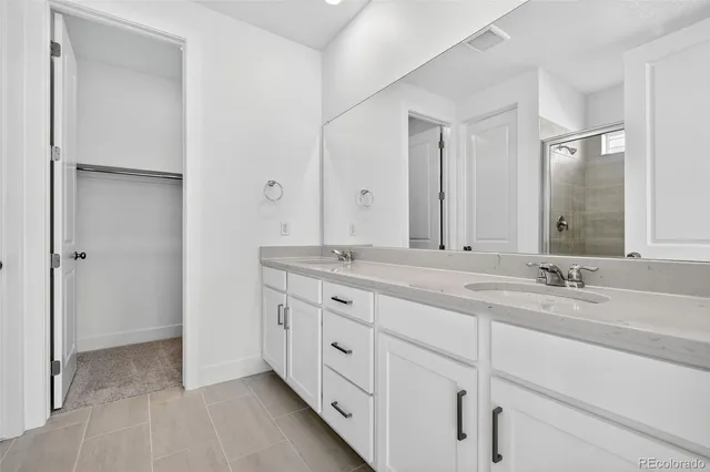a bathroom with double sink and a mirror
