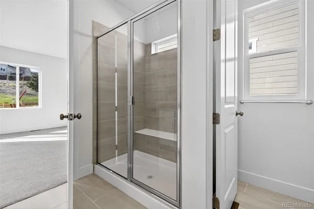 a bathroom with a glass shower door