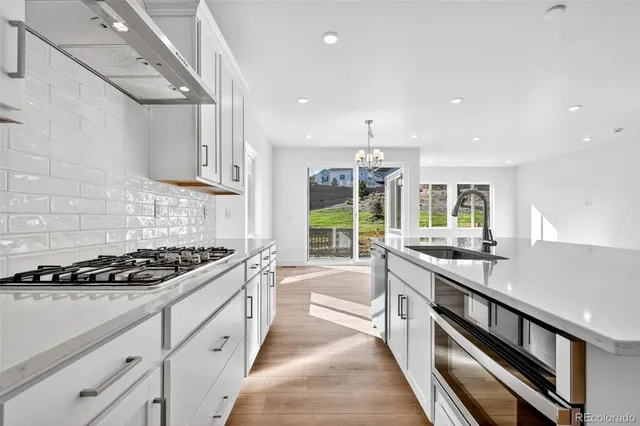 a kitchen with stainless steel appliances granite countertop a sink and cabinets