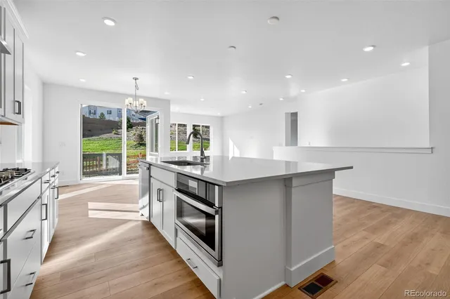 a kitchen with stainless steel appliances granite countertop a stove and a sink