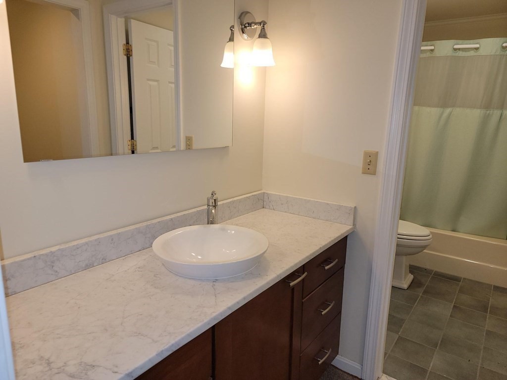 174 Lowell Road, Unit 24 Mashpee, MA 02649 - Photo 12 of 16 a bathroom with a sink and a mirror