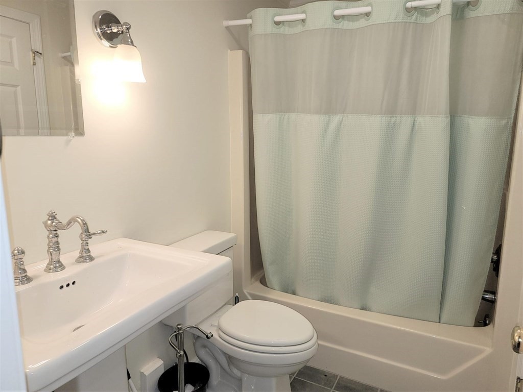 174 Lowell Road, Unit 24 Mashpee, MA 02649 - Photo 13 of 16 a bathroom with a sink a toilet and a bathtub