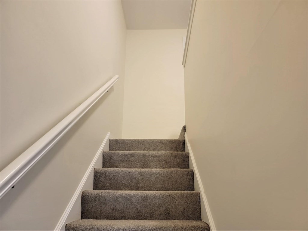 174 Lowell Road, Unit 24 Mashpee, MA 02649 - Photo 7 of 16 a view of staircase with white walls