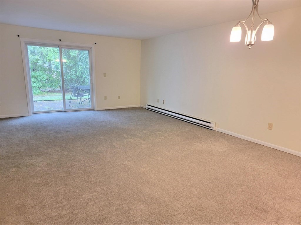 174 Lowell Road, Unit 24 Mashpee, MA 02649 - Photo 9 of 16 a view of empty room with window