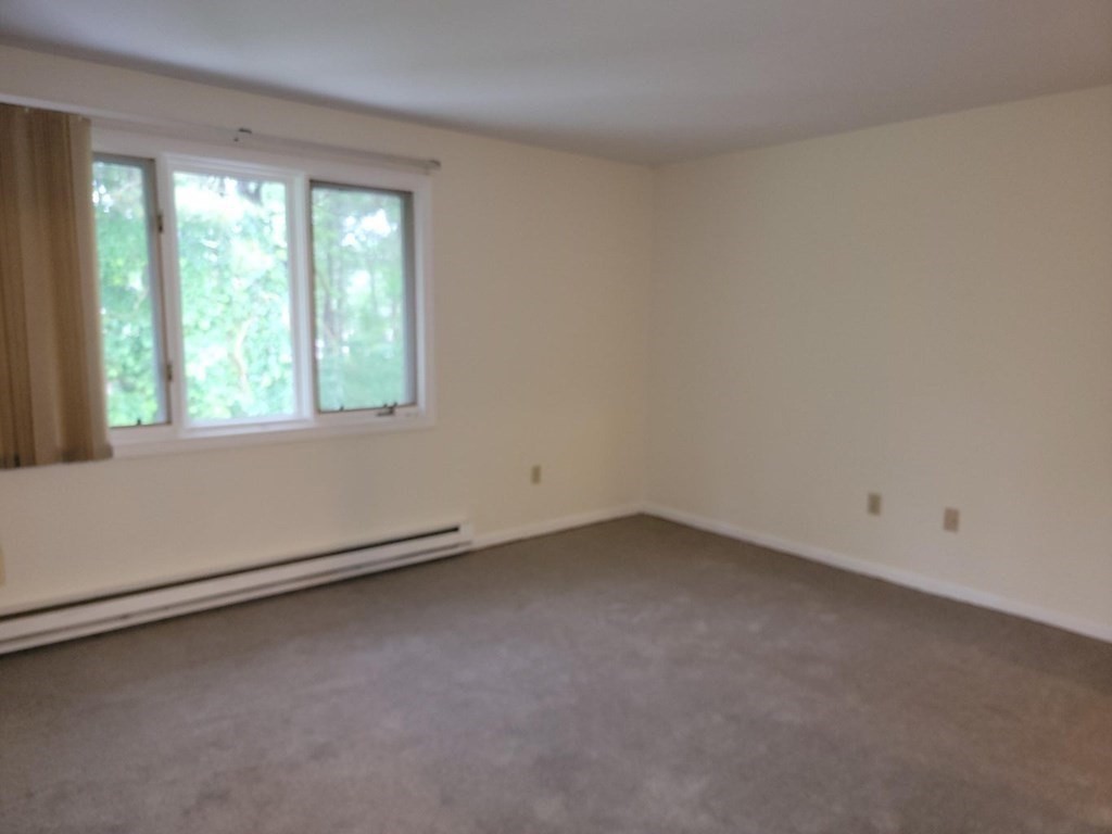 174 Lowell Road, Unit 24 Mashpee, MA 02649 - Photo 10 of 16 an empty room with a window