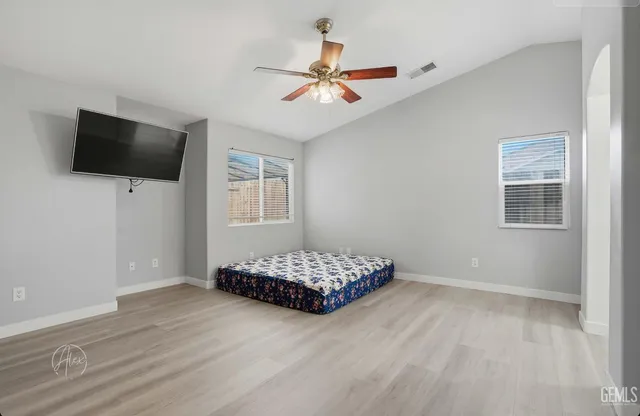 a living room with hardwood floor and flat screen tv