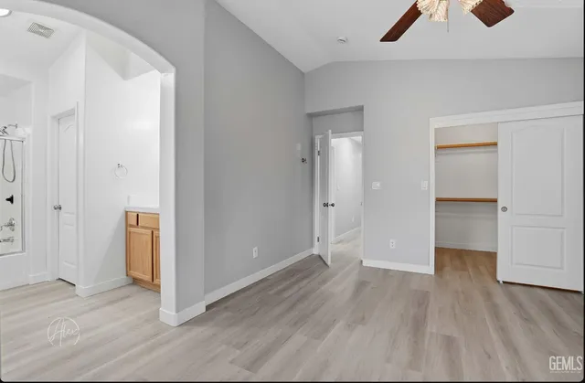 an empty room with wooden floor and closet