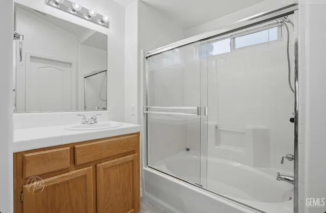 a bathroom with a shower and a sink