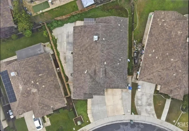an aerial view of a house with a yard