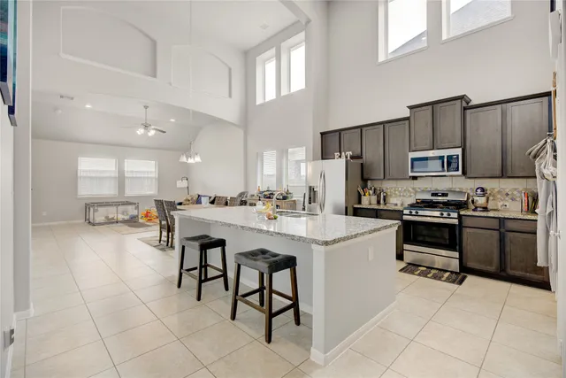 a kitchen with a sink stainless steel appliances and cabinets