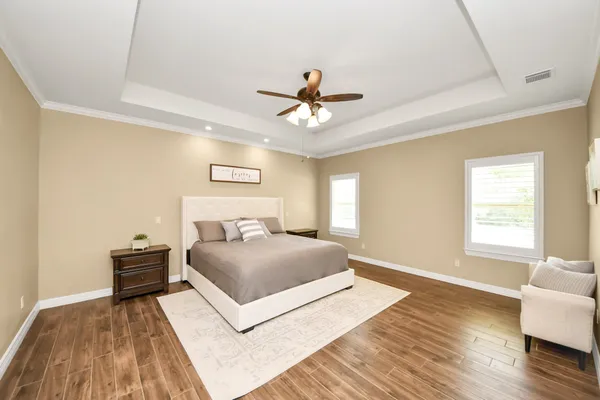 a living room with furniture and a wooden floor