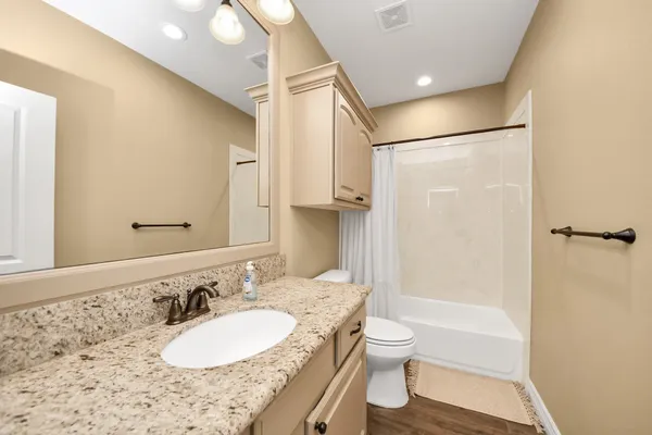 a view of an house with backyard space and balcony