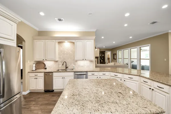 a bathroom with a tub a sink and a large mirror