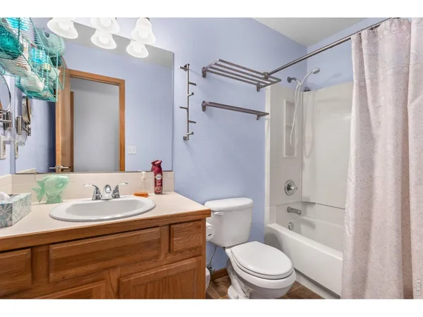 a bathroom with a sink toilet a mirror and shower