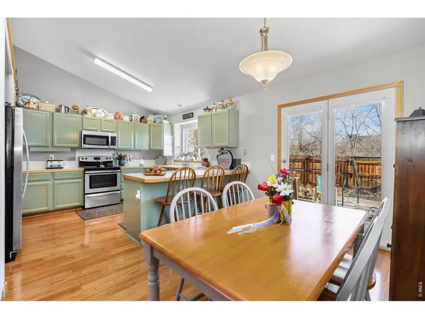 a kitchen with sink refrigerator and large window