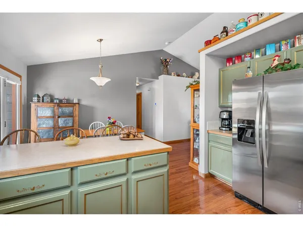 a kitchen with refrigerator and cabinets