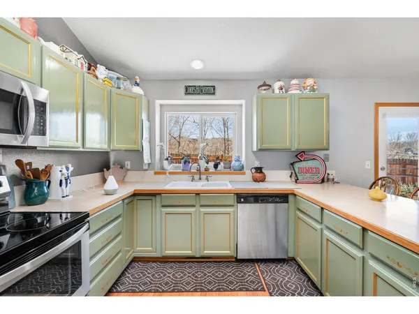 a kitchen with a sink stove and cabinets