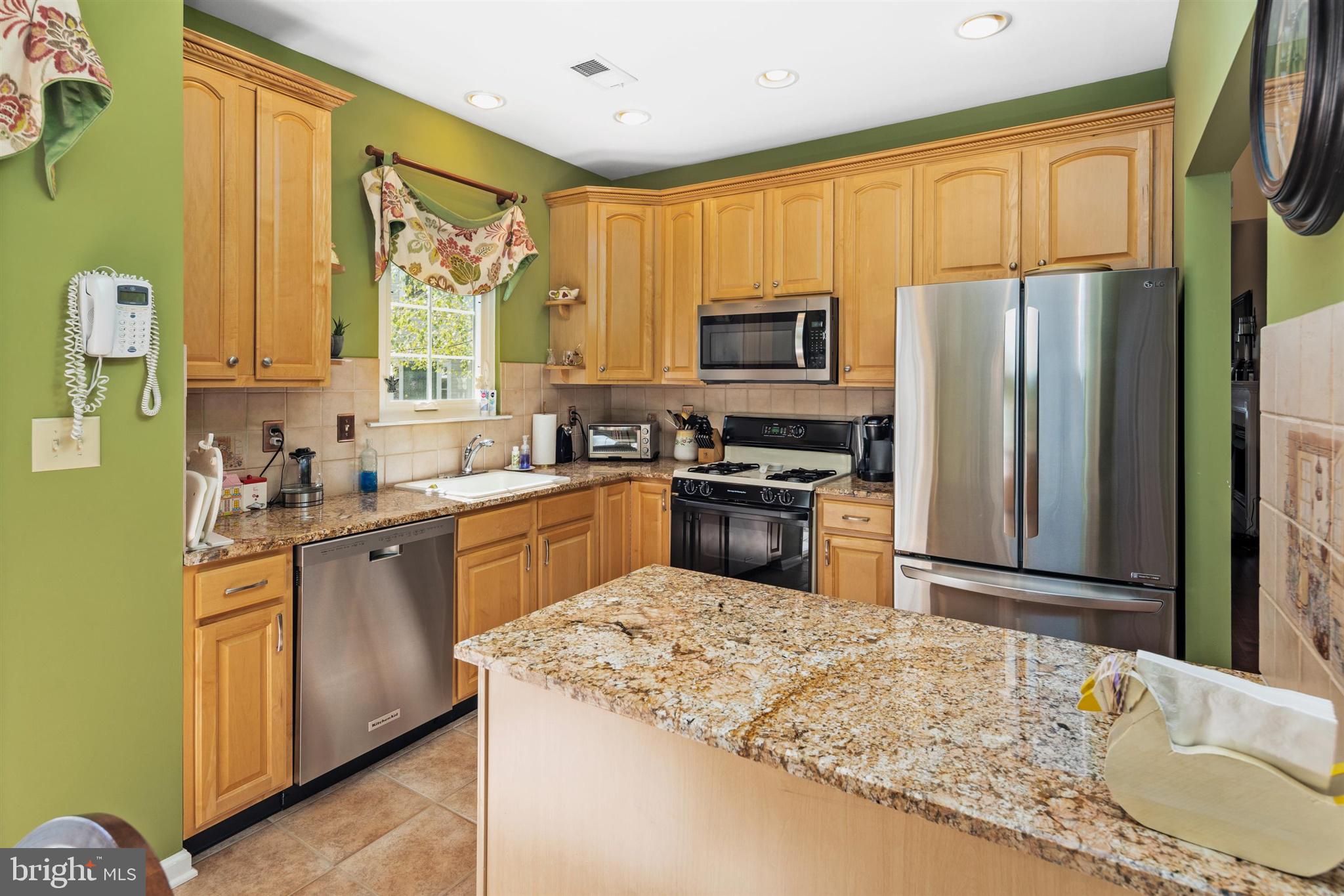 16 Winterberry Terrace Hamilton, NJ 08690 - Photo 9 of 26 a kitchen with stainless steel appliances granite countertop a sink refrigerator stove microwave and cabinets